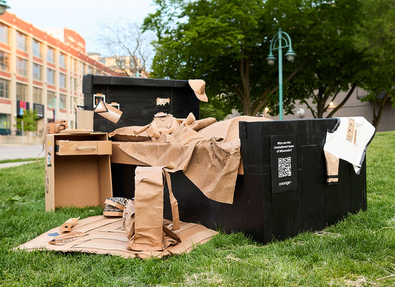 Cardboard bed art exhibit on display at live location.