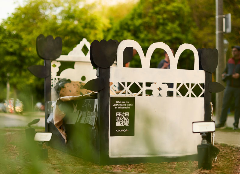Cardboard bed art exhibit on display at live location.
