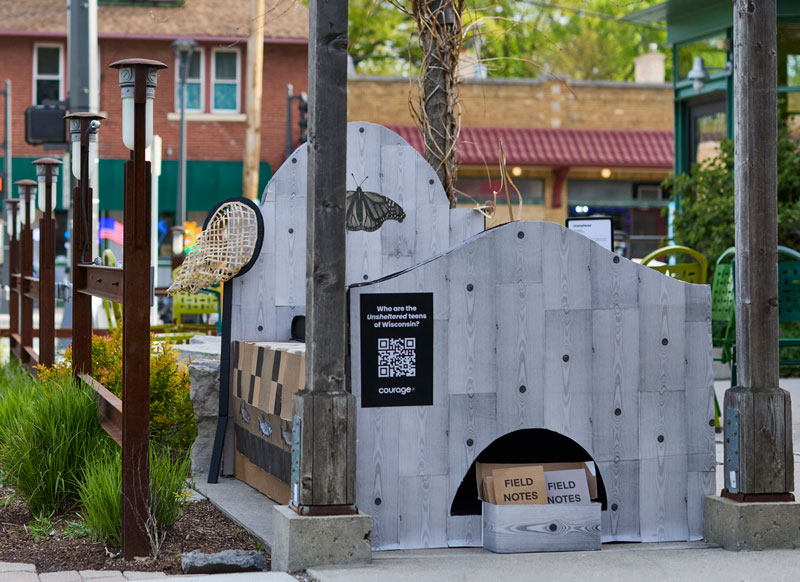 Cardboard bed art exhibit on display at live location.
