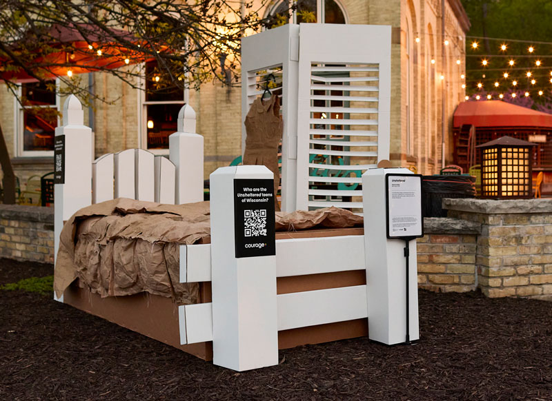 Cardboard bed art exhibit on display at live location.