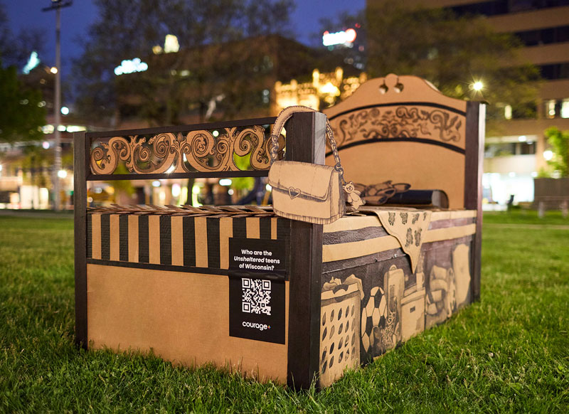 Cardboard bed art exhibit on display at live location.